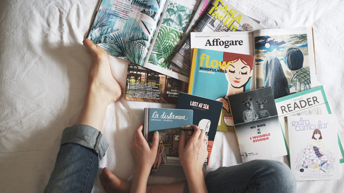 Flay lay of Woman Reading Magazines on Bed